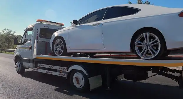 Car loaded on a flatbed tow truck