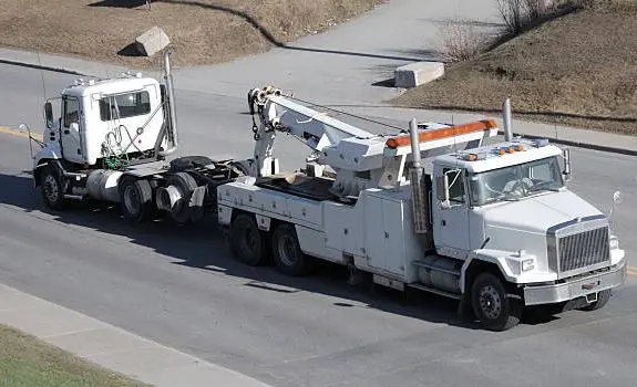 Heavy duty wrecker towing a truck